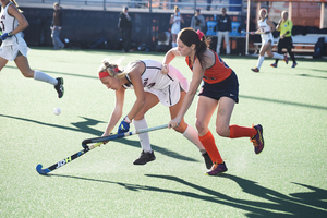 Liz Sack fights for a loose ball on Sunday against UConn. The Orange struggled to generate offense throughout much of the game and then couldn't crack through in overtime.